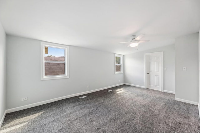 carpeted empty room with ceiling fan and baseboards