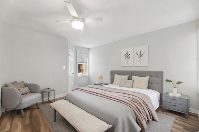 bedroom with light wood finished floors, ceiling fan, and baseboards