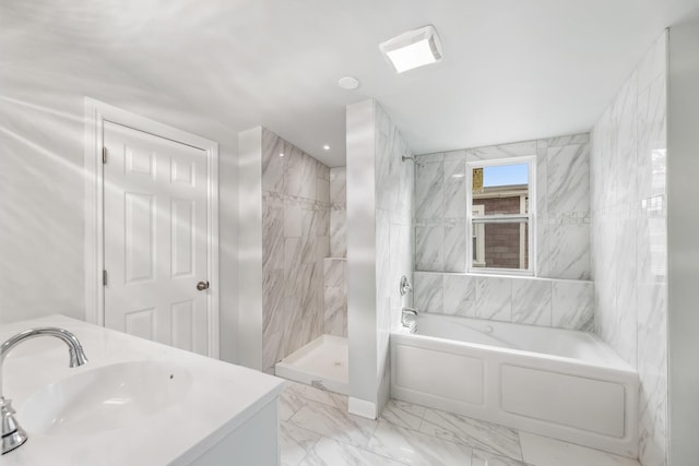 bathroom with a sink, a garden tub, marble finish floor, and tiled shower