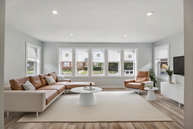 living area with recessed lighting, wood finished floors, and baseboards