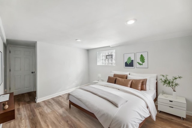 bedroom featuring recessed lighting, baseboards, and wood finished floors