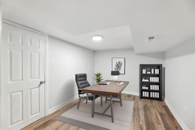 office with visible vents, baseboards, and light wood finished floors