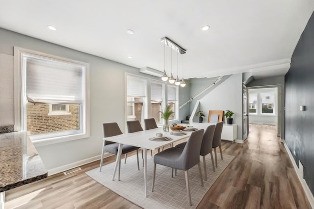 dining area featuring visible vents, recessed lighting, wood finished floors, and baseboards