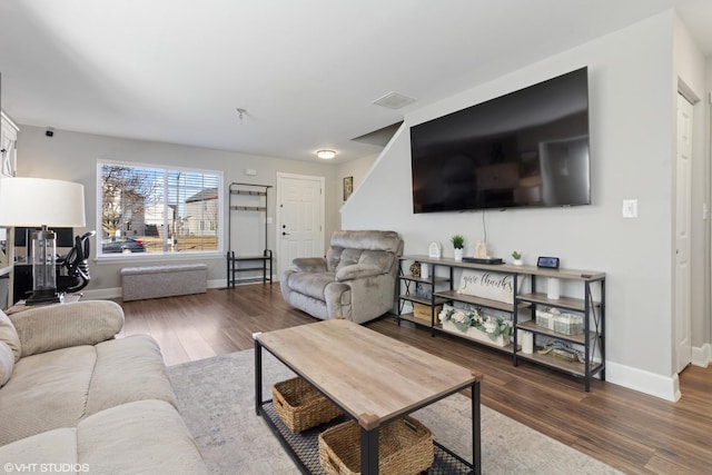 living area featuring dark wood-type flooring and baseboards