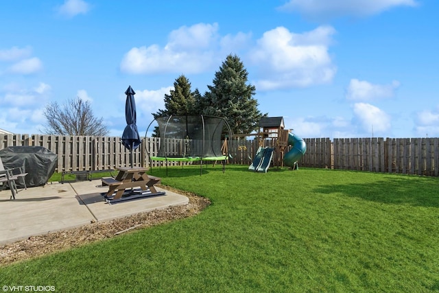 view of yard with a fenced backyard, a patio, playground community, and a trampoline