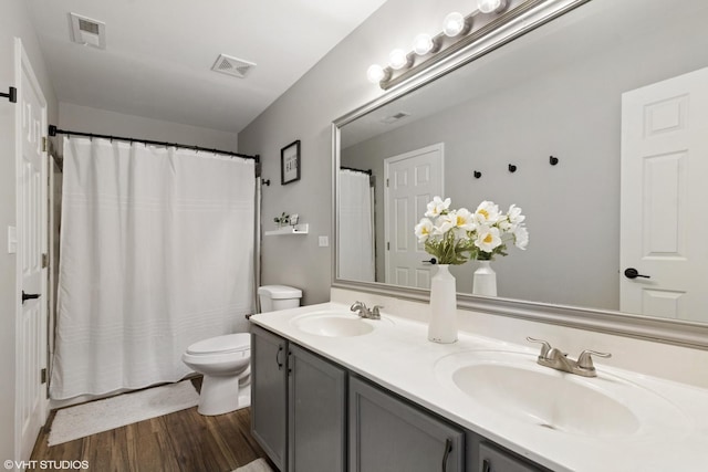 bathroom with a sink, visible vents, and toilet