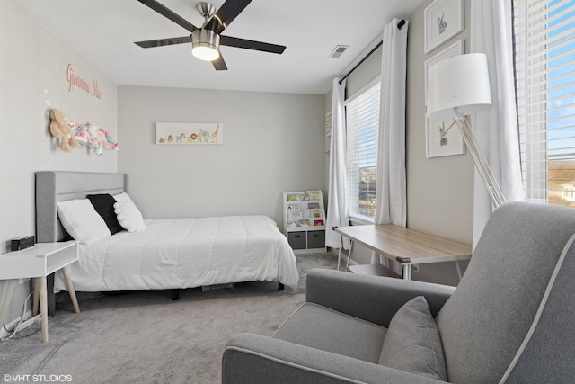 bedroom with visible vents, carpet, and a ceiling fan