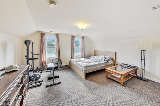 carpeted bedroom with vaulted ceiling, baseboards, and visible vents