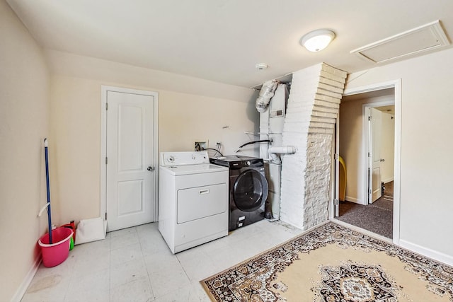 laundry area featuring baseboards, attic access, washing machine and dryer, and laundry area