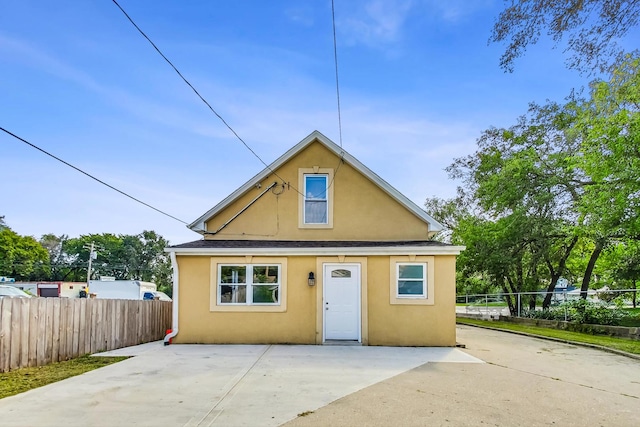 bungalow-style house featuring a patio area, stucco siding, a shingled roof, and fence