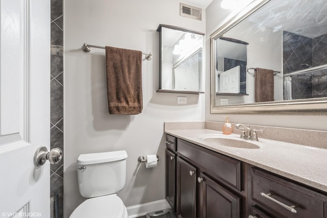 full bath with vanity, toilet, baseboards, and visible vents