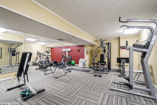 gym with baseboards and carpet floors