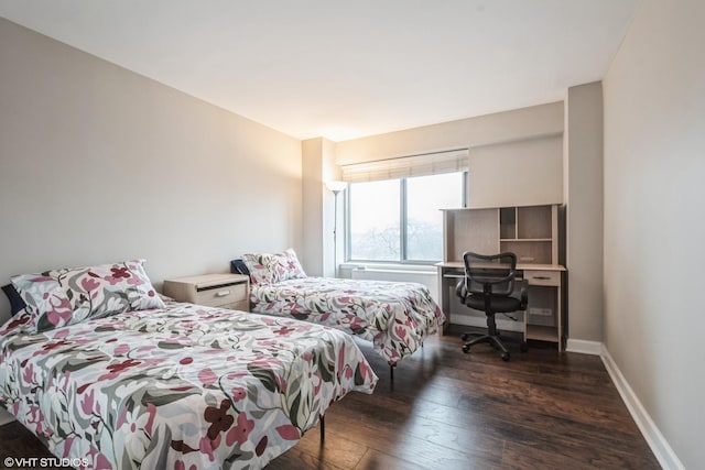 bedroom featuring baseboards and wood-type flooring