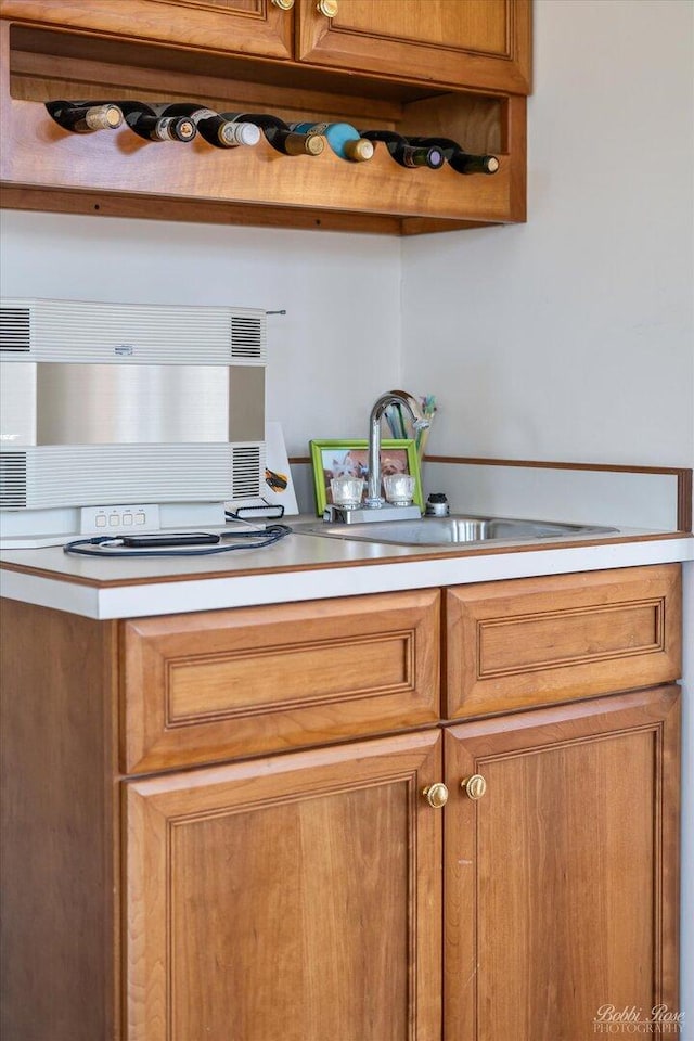 kitchen featuring a sink, light countertops, and brown cabinets