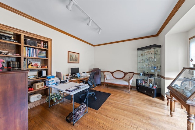 office area with wood finished floors, ornamental molding, and rail lighting