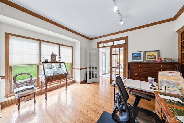 home office with light wood-style flooring, track lighting, french doors, and plenty of natural light