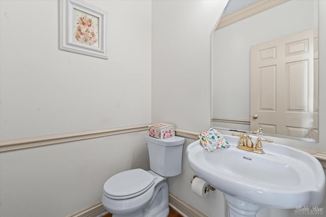half bath with a sink and toilet