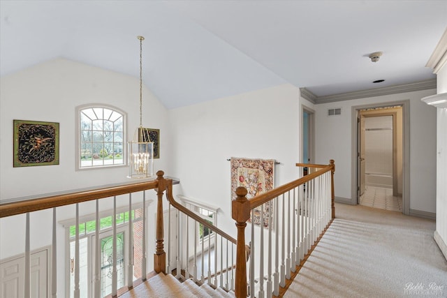 corridor with visible vents, baseboards, a notable chandelier, an upstairs landing, and light colored carpet