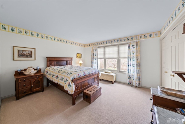 carpeted bedroom featuring baseboards