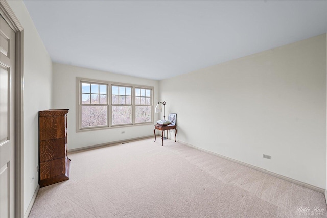 unfurnished room featuring baseboards and carpet flooring