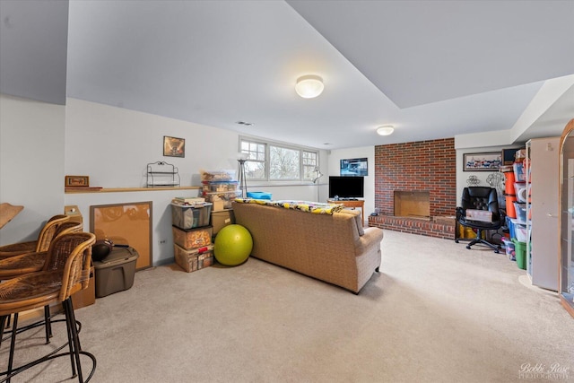 living area featuring visible vents, carpet flooring, and a fireplace