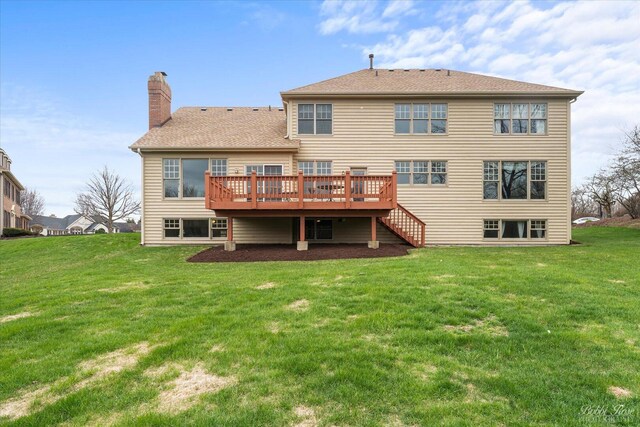 back of house with a wooden deck, stairway, a lawn, a chimney, and a shingled roof