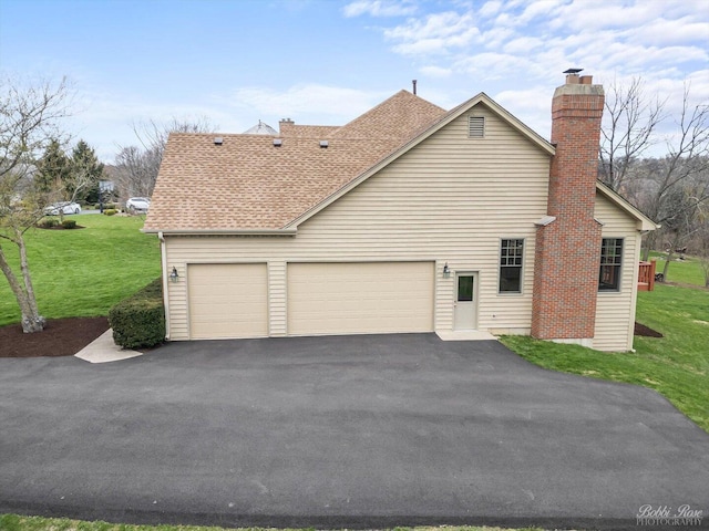 view of property exterior with aphalt driveway, a yard, roof with shingles, and an attached garage