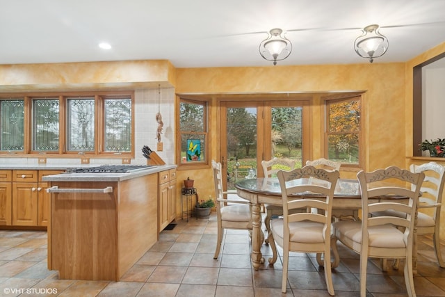 dining room with light tile patterned flooring and recessed lighting