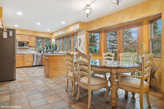 dining room featuring light tile patterned floors and recessed lighting