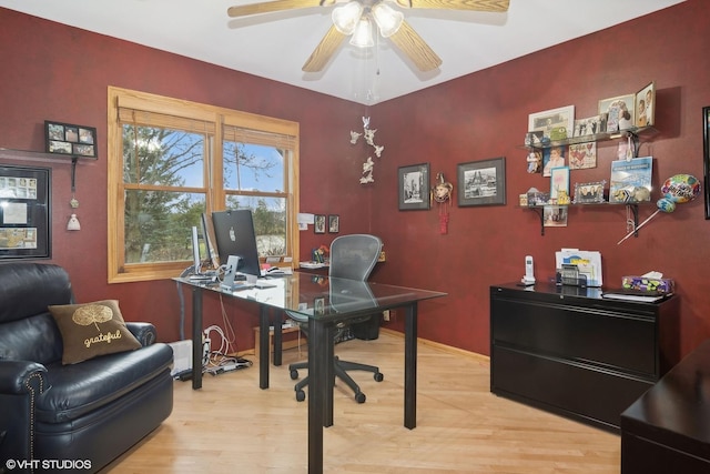 home office featuring baseboards, a ceiling fan, and light wood finished floors