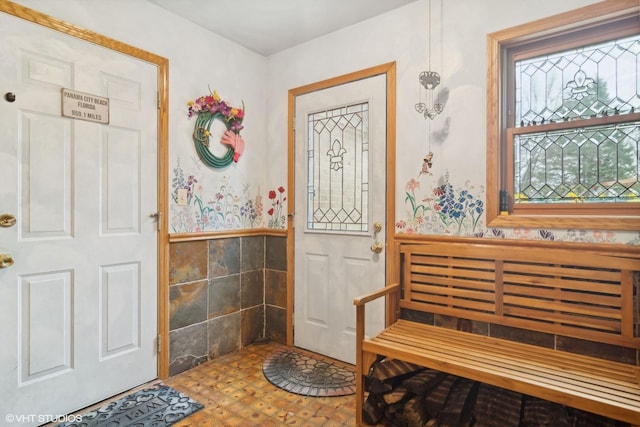 foyer entrance with a wainscoted wall