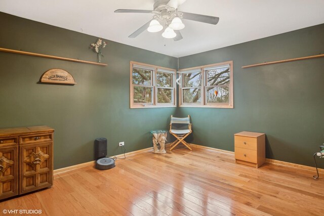 miscellaneous room with ceiling fan, baseboards, and wood finished floors