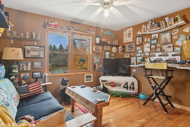 interior space featuring wood-type flooring and ceiling fan