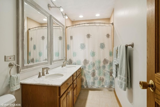 full bathroom with a sink, toilet, a shower with shower curtain, and double vanity