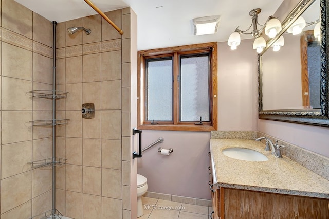 full bath featuring vanity, baseboards, a tile shower, tile patterned floors, and toilet