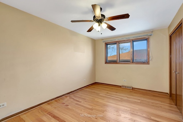 unfurnished bedroom with visible vents, ceiling fan, baseboards, light wood-style floors, and a closet