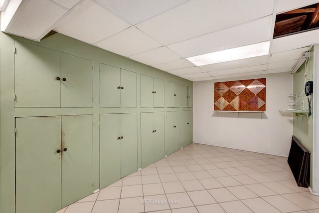 basement with a paneled ceiling