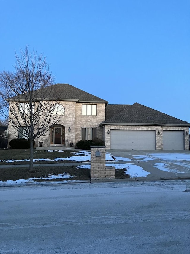 view of front of house featuring concrete driveway, an attached garage, brick siding, and roof with shingles