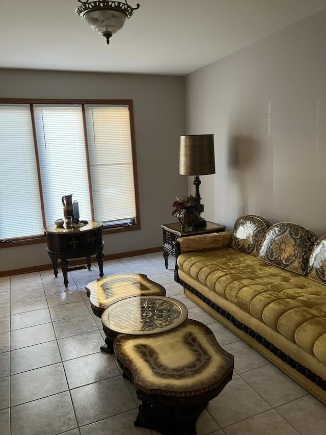 living room with baseboards and light tile patterned flooring