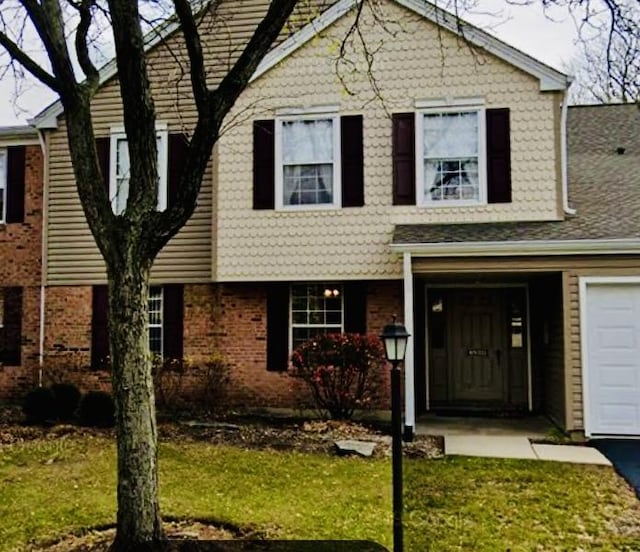 view of front of house featuring aphalt driveway, an attached garage, and brick siding