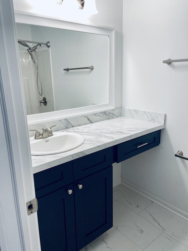 full bathroom with a shower, baseboards, marble finish floor, and vanity