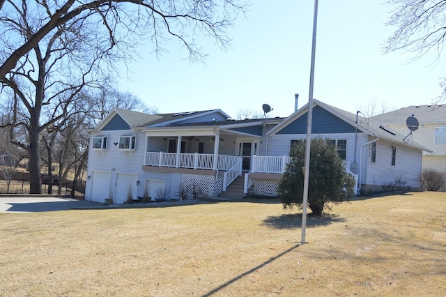 view of front of home featuring stairway, covered porch, a front lawn, concrete driveway, and a garage