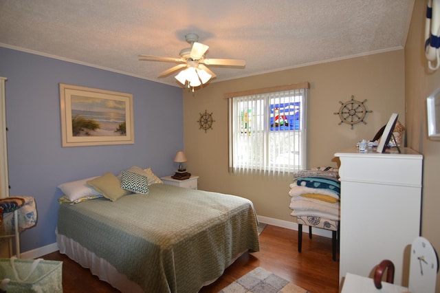 bedroom featuring ornamental molding, a textured ceiling, baseboards, and wood finished floors