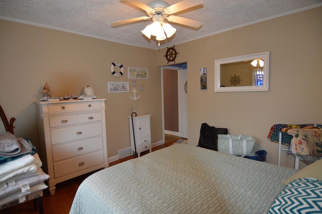 bedroom featuring a ceiling fan, dark wood-type flooring, a textured ceiling, and crown molding