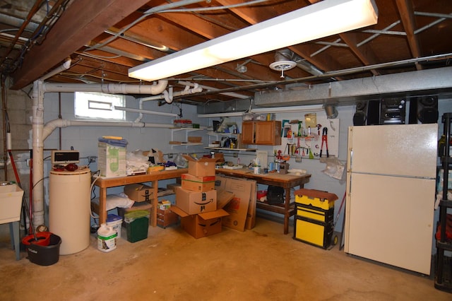 basement featuring freestanding refrigerator