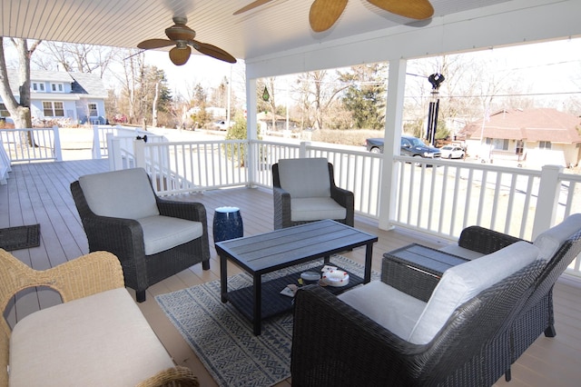 wooden deck featuring an outdoor living space, a ceiling fan, and a residential view