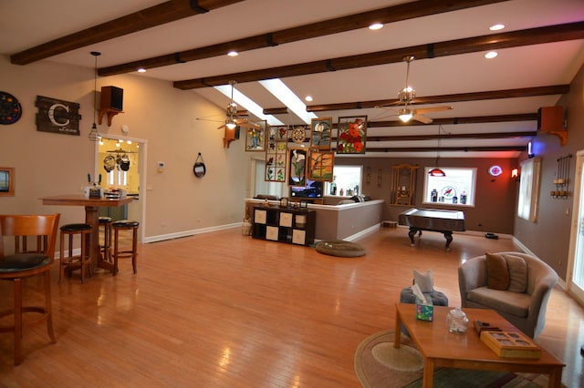 living area featuring baseboards, ceiling fan, wood finished floors, a bar, and billiards