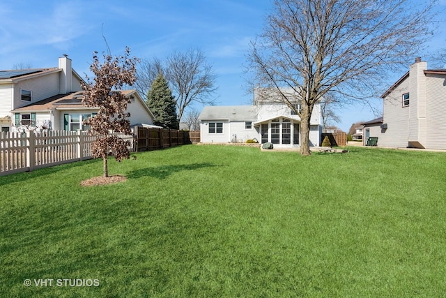 view of yard featuring a sunroom and fence