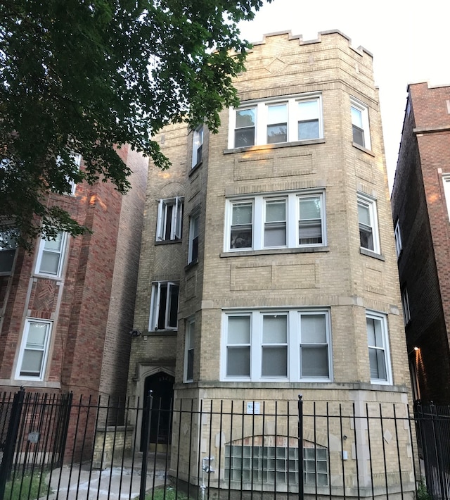 view of building exterior with fence