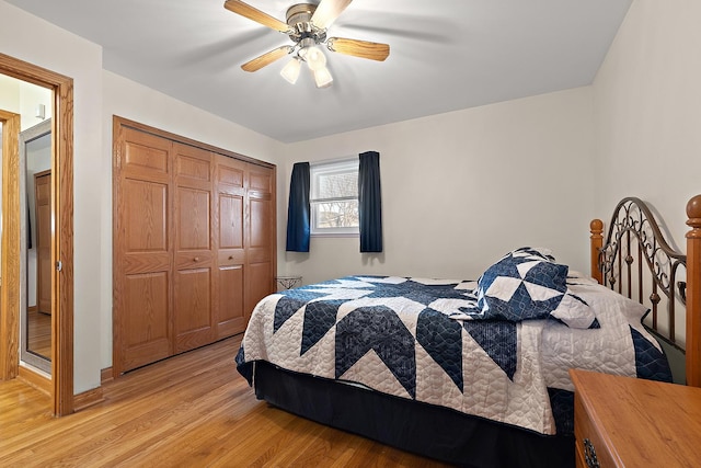 bedroom with light wood-style floors, a closet, and ceiling fan